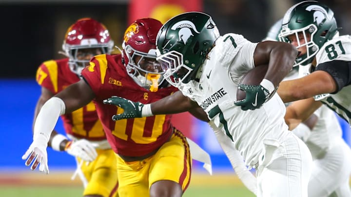 Michigan State RB Brandon Tullis carries the ball as USC DE Braylan Shelby closes in during the Spartans' and Trojans' matchup on Sept. 20, 2025. USC won 45-31.