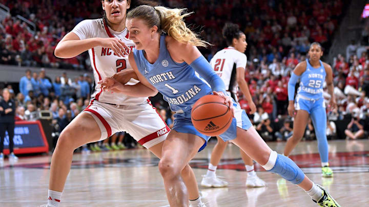 North Carolina's Alyssa Ustby (1) drives to the basket against N.C State's Mimi Collins (2) during