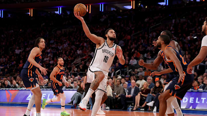 Nov 15, 2024; New York, New York, USA; Brooklyn Nets guard Ben Simmons (10) takes a shot against New York Knicks forward Mikal Bridges (25) and center Ariel Hukporti (55) during the second quarter at Madison Square Garden. Mandatory Credit: Brad Penner-Imagn Images