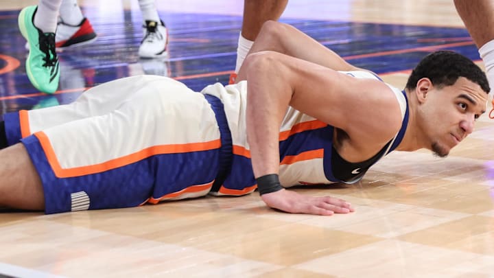 Jan 3, 2026; New York, New York, USA;  New York Knicks guard Kevin McCullar Jr. (9) lies on the court after a turnover in the first quarter against the Philadelphia 76ers at Madison Square Garden. Mandatory Credit: Wendell Cruz-Imagn Images