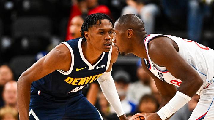 Oct 12, 2025; Inglewood, California, USA; Los Angeles Clippers guard Kris Dunn (8) looks to pass against Denver Nuggets forward Peyton Watson (8) during the third period at Intuit Dome. Mandatory Credit: Jonathan Hui-Imagn Images