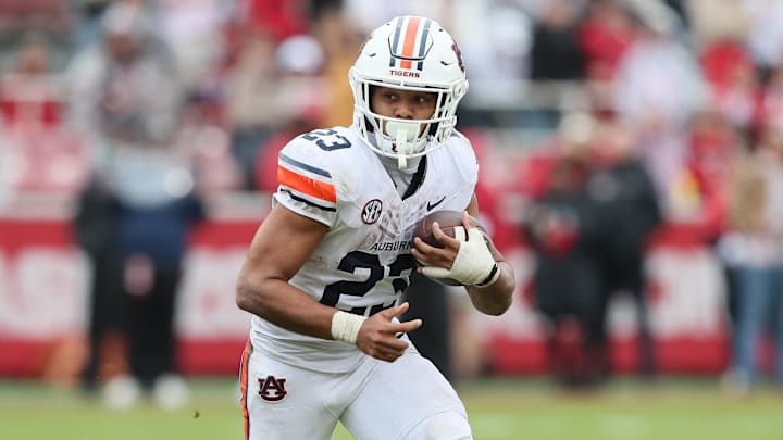 Oct 25, 2025; Fayetteville, Arkansas, USA; Auburn Tigers running back Jeremiah Cobb (23) rushes during the fourth quarter against the Arkansas Razorbacks at Donald W. Reynolds Razorback Stadium. Mandatory Credit: Nelson Chenault-Imagn Images