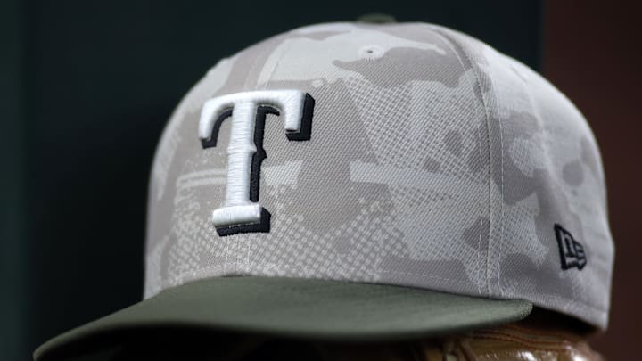 May 18, 2025; Arlington, Texas, USA;  Texas Rangers hat in honor of the military in the dugout  during the second inning against the Houston Astros at Globe Life Field. 