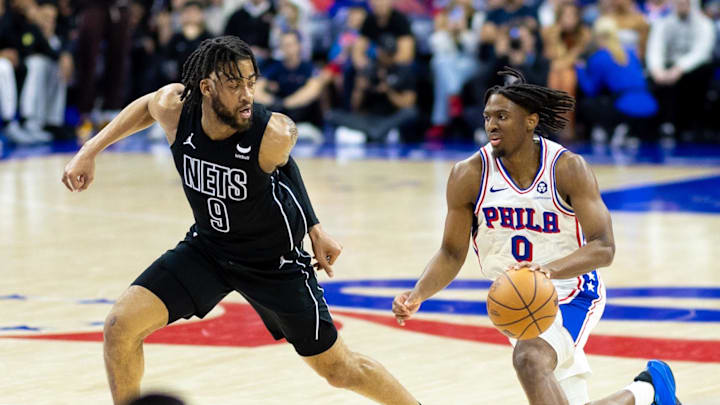 Apr 14, 2024; Philadelphia, Pennsylvania, USA; Philadelphia 76ers guard Tyrese Maxey (0) dribbles the ball against Brooklyn Nets forward Trendon Watford (9) during the second quarter at Wells Fargo Center. Mandatory Credit: Bill Streicher-Imagn Images