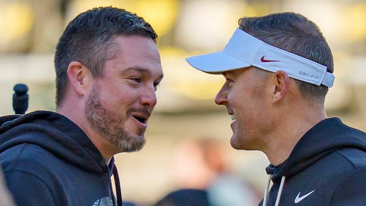 Oregon head coach Dan Lanning, left, and USC head coach Lincoln Riley shake hands before the game as the Oregon Ducks host the USC Trojans on Nov. 22, 2025, at Autzen Stadium in Eugene, Oregon.