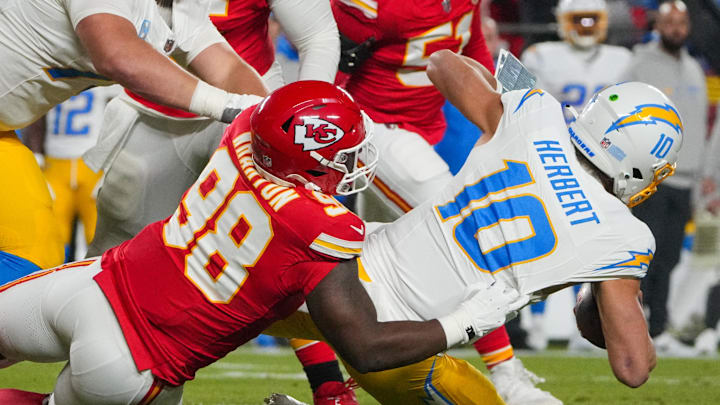 Dec 8, 2024; Kansas City, Missouri, USA; Los Angeles Chargers quarterback Justin Herbert (10) is sacked by Kansas City Chiefs defensive tackle Tershawn Wharton (98) during the first half at GEHA Field at Arrowhead Stadium. Mandatory Credit: Denny Medley-Imagn Images