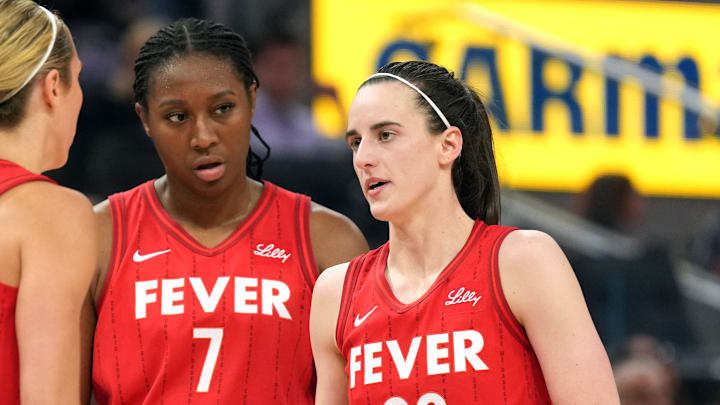 Jun 19, 2025; San Francisco, California, USA; Indiana Fever guard Caitlin Clark (22) talks to guard Lexie Hull (left) and forward Aliyah Boston (7) during the third quarter against the Golden State Valkyries at Chase Center. Mandatory Credit: Darren Yamashita-Imagn Images