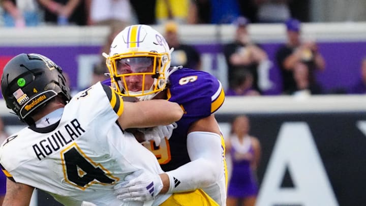 Sep 14, 2024; Greenville, North Carolina, USA; East Carolina Pirates defensive lineman J.D. Lampley (9) stops the run by Appalachian State Mountaineers quarterback Joey Aguilar (4) during the second half at Dowdy-Ficklen Stadium. Mandatory Credit: James Guillory-Imagn Images Sep 14, 2024; Greenville, North Carolina, USA; East Carolina Pirates defensive lineman J.D. Lampley (9) stops the run by Appalachian State Mountaineers quarterback Joey Aguilar (4) during the second half at Dowdy-Ficklen Stadium. Mandatory Credit: James Guillory-Imagn Images