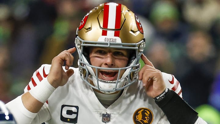 Nov 23, 2023; Seattle, Washington, USA; San Francisco 49ers quarterback Brock Purdy (13) signals while over center against the Seattle Seahawks during the second quarter at Lumen Field. Mandatory Credit: Joe Nicholson-Imagn Images