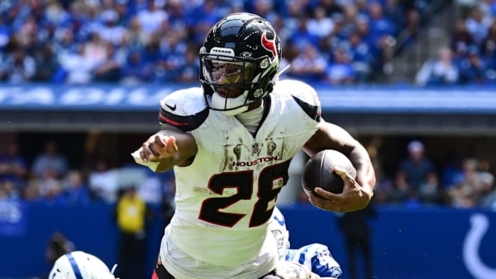 Sep 8, 2024; Indianapolis, Indiana, USA; Houston Texans running back Joe Mixon (28) out runs Indianapolis Colts cornerback Jaylon Jones (40) during the second half at Lucas Oil Stadium. Mandatory Credit: Marc Lebryk-Imagn Images