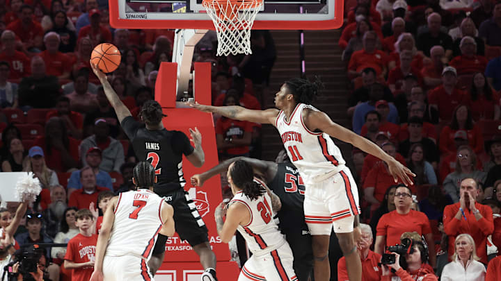 Mar 1, 2025; Houston, Texas, USA; Cincinnati Bearcats guard Jizzle James (2) shoots against Houston Cougars forward Joseph Tugler (11) in the first half at Fertitta Center. Mandatory Credit: Thomas Shea-Imagn Images