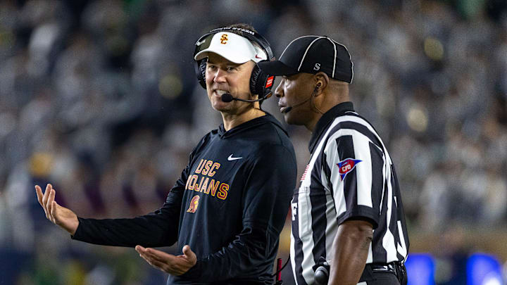 Oct 18, 2025; South Bend, Indiana, USA; Southern California Trojans head coach Lincoln Riley talks to an official during the first half against the Notre Dame Fighting Irish at Notre Dame Stadium. Mandatory Credit: Michael Caterina-Imagn Images