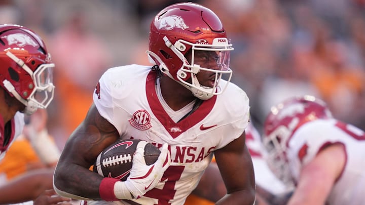 Arkansas running back Mike Washington Jr. runs the ball in an NCAA college football game against Tennessee. Arkansas running back Mike Washington Jr. runs the ball in an NCAA college football game against Tennessee.