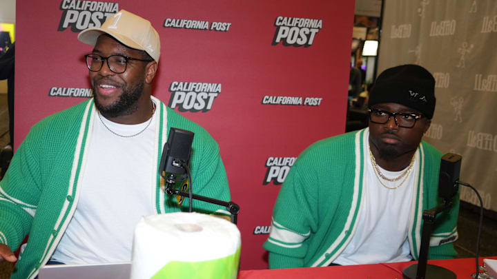 Feb 4, 2026; San Francisco, CA, USA; Los Angeles Rams defensive end Kobie Turner (left) and linebacker Byron Young at the California Post booth at the Super Bowl LX media center at the Moscone Center. Mandatory Credit: Kirby Lee-Imagn Images