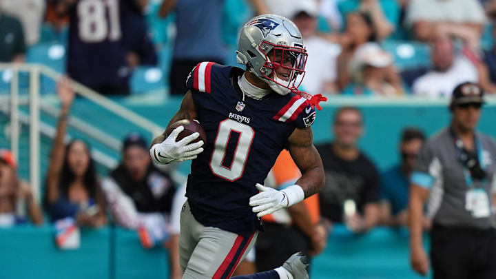 Nov 24, 2024; Miami Gardens, Florida, USA; New England Patriots cornerback Christian Gonzalez (0) runs the ball for a touchdown after recovering a fumble against the Miami Dolphins during the second half at Hard Rock Stadium. Mandatory Credit: Jasen Vinlove-Imagn Images