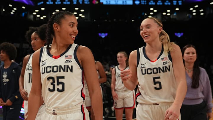 Dec 7, 2024; Brooklyn, New York, USA; Connecticut Huskies guard Azzi Fudd (35) and Connecticut Huskies guard Paige Bueckers (5) celebrate after the game against the Louisville Cardinals at Barclays Center. Mandatory Credit: Lucas Boland-Imagn Images