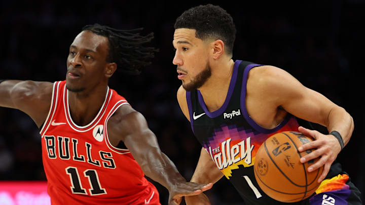 Mar 5, 2026; Phoenix, Arizona, USA; Phoenix Suns guard Devin Booker (1) dribbles against Chicago Bulls forward Leonard Miller (11) in the fourth quarter at Mortgage Matchup Center. Mandatory Credit: Anna Carrington-Imagn Images