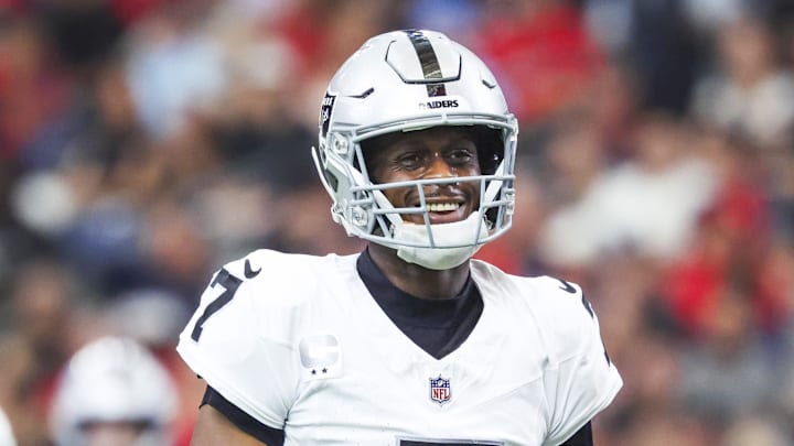 Dec 21, 2025; Houston, Texas, USA; Las Vegas Raiders quarterback Geno Smith (7) reacts after throwing a touchdown pass against the Houston Texans during the second quarter at NRG Stadium.  