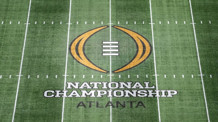 The College Football Playoff National Championship logo at midfield at Mercedes-Benz Stadium. The College Football Playoff National Championship logo at midfield at Mercedes-Benz Stadium.