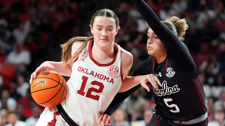 Oklahoma's Payton Verhulst (12) drives to the basket as South Carolina 's Tessa Johnson (5) defends in the second half of the women's college basketball game between the Oklahoma Sooners and the South Carolina at the Lloyd Noble Center in Norman, Okla., Thursday Jan. 22, 2026.