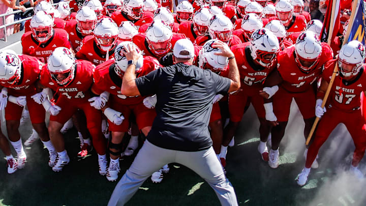 Oct 4, 2025; Raleigh, North Carolina, USA; NC State Wolfpack head coach Dave Doeren with his team prepare to run out prior to the first half of the game against Campbell Fighting Camels at Carter-Finley Stadium. Mandatory Credit: Jaylynn Nash-Imagn Images Oct 4, 2025; Raleigh, North Carolina, USA; NC State Wolfpack head coach Dave Doeren with his team prepare to run out prior to the first half of the game against Campbell Fighting Camels at Carter-Finley Stadium. Mandatory Credit: Jaylynn Nash-Imagn Images