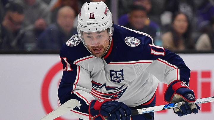 Dec 22, 2025; Los Angeles, California, USA; Columbus Blue Jackets left wing Miles Wood (11) moves the puck ahead of Los Angeles Kings defenseman Brian Dumoulin (2) during the third period at Crypto.com Arena. Mandatory Credit: Gary A. Vasquez-Imagn Images