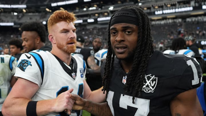 Carolina Panthers quarterback Andy Dalton (14) shakes hands with Las Vegas Raiders wide receiver Davante Adams (17) Carolina Panthers quarterback Andy Dalton (14) shakes hands with Las Vegas Raiders wide receiver Davante Adams (17)