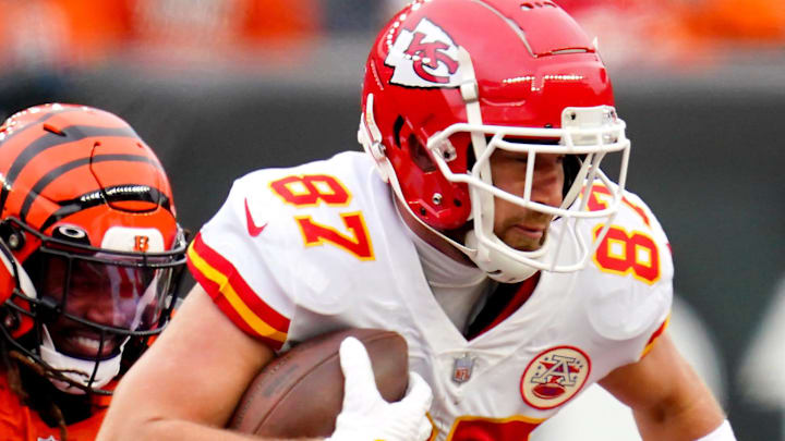 Kansas City Chiefs tight end Travis Kelce (87) maintains possession after a catch as Cincinnati Bengals cornerback Tre Flowers (33) defends in the second quarter during a Week 17 NFL game, Sunday, Jan. 2, 2022, at Paul Brown Stadium in Cincinnati.