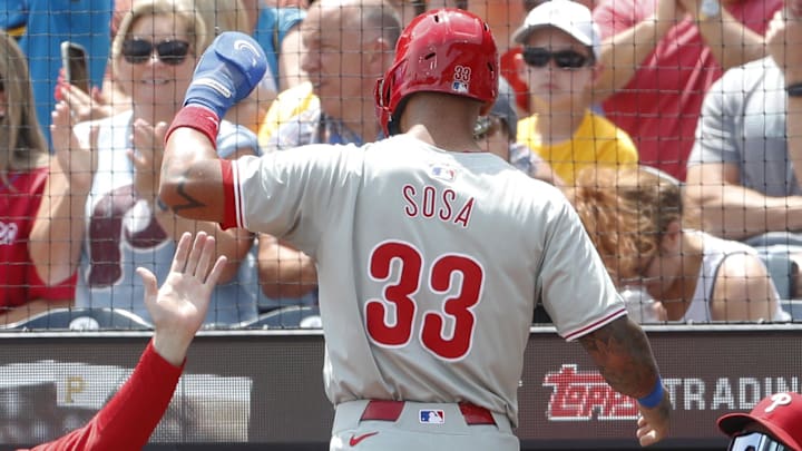 Jul 21, 2024; Pittsburgh, Pennsylvania, USA;  Philadelphia Phillies manager Rob Thomson (left) greets second baseman Edmundo Sosa (3) at the dugout after Sosa scored a run against the Pittsburgh Pirates during the second inning at PNC Park