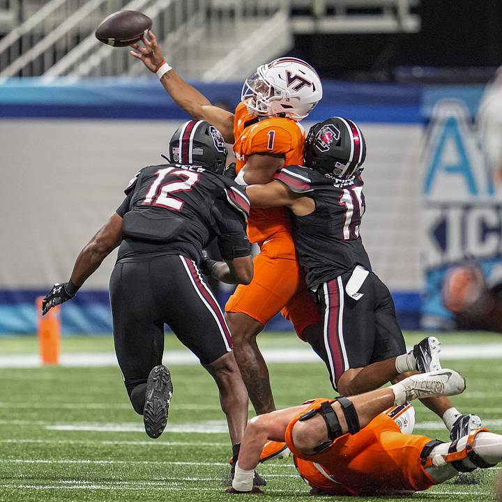 Virginia Tech Hokies quarterback Kyron Drones is hit by South Carolina Gamecocks defensive back Brandon Cisse 