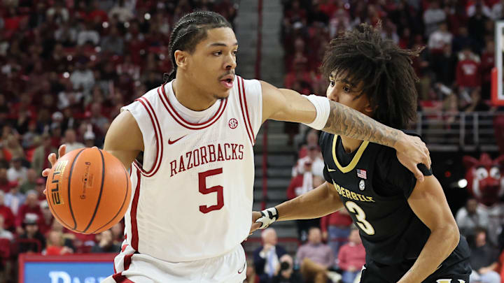 Arkansas Razorbacks guard Darius Acuff Jr (5) drives against Vanderbilt Commodores guard Tyler Tanner (3) during the first half against at Bud Walton Arena.