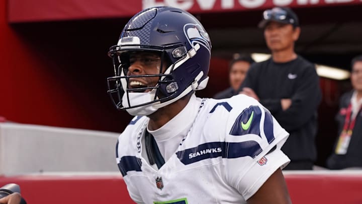 Nov 17, 2024; Santa Clara, California, USA; Seattle Seahawks quarterback Geno Smith (7) celebrates after scoring a rushing touchdown past San Francisco 49ers cornerback Isaac Yiadom (22) to win the game in the fourth quarter at Levi's Stadium.