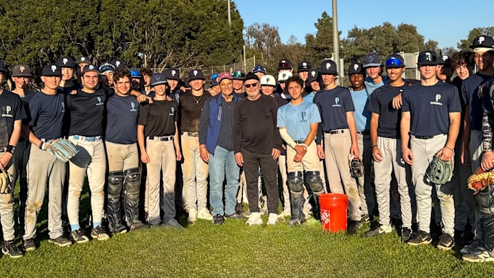 Joe Torre and Billy Crystal (middle) surprised the Palisades Charter baseball team at practice Thursday afternoon.