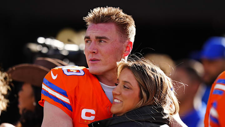 Denver Broncos quarterback Bo Nix (10) hugs wife, Izzy Nix before the game against the Los Angeles Chargers at Empower Field at Mile High. Mandatory Credit: Ron Chenoy-Imagn Images