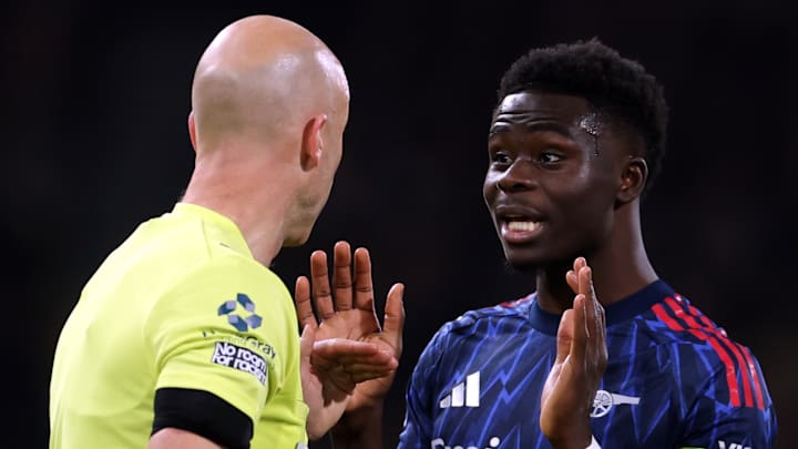 Bukayo Saka (right) appealed to Anthony Taylor (left) after the penalty was overturned.
