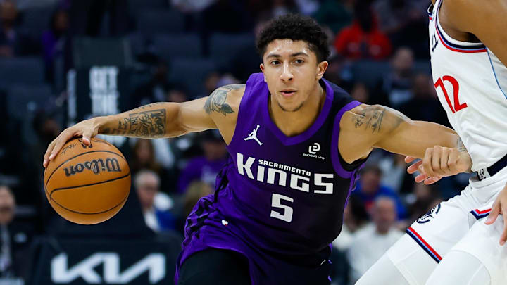 Feb 6, 2026; Sacramento, California, USA; Sacramento Kings guard Nique Clifford (5) dribbles against Los Angeles Clippers guard Cam Christie (12) during the first quarter at Golden 1 Center.