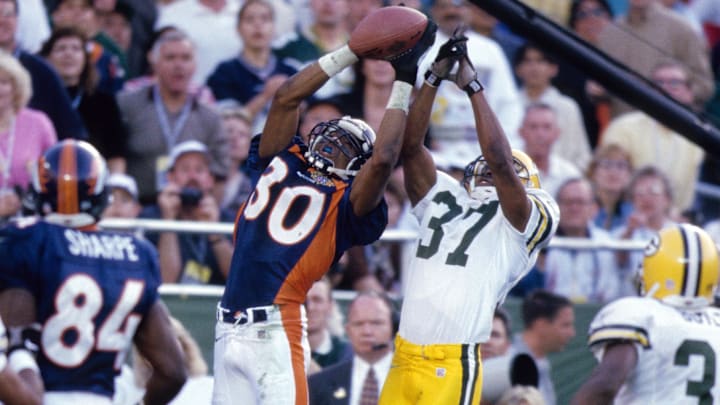 Jan 25, 1998; San Diego, CA, USA; FILE PHOTO; Denver Broncos receiver Rod Smith (80) in action against Green Bay Packers cornerback Tyrone Williams (37) during Super Bowl XXXII at Qualcomm Stadium. The Broncos defeated the Packers 31-24. Jan 25, 1998; San Diego, CA, USA; FILE PHOTO; Denver Broncos receiver Rod Smith (80) in action against Green Bay Packers cornerback Tyrone Williams (37) during Super Bowl XXXII at Qualcomm Stadium. The Broncos defeated the Packers 31-24.