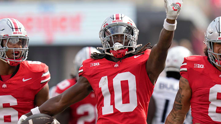 Aug 31, 2024; Columbus, OH, USA; Ohio State Buckeyes cornerback Denzel Burke (10) celebrates an interception with safety Sonny Styles (6) and safety Lathan Ransom (8) during the first half of the NCAA football game against the Akron Zips at Ohio Stadium.