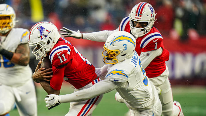 Dec 3, 2023; Foxborough, Massachusetts, USA; New England Patriots wide receiver Tyquan Thornton (11) runs the ball against Los Angeles Chargers safety Derwin James Jr. (3) in the second half at Gillette Stadium.
