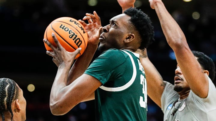Michigan State forward Xavier Booker (34) is defended by Mississippi State guard Shakeel Moore (3) and forward Tolu Smith (1) during the second half of NCAA tournament West Region first round at Spectrum Center in Charlotte, N.C. on Thursday, March 21, 2024.