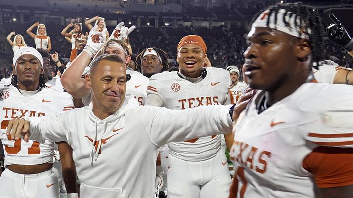 Texas Longhorns head coach Steve Sarkisian reacts with defensive linemen Colin Simmons (1) after beating the Mississippi State Bulldogs in overtime at Davis Wade Stadium at Scott Field. Texas Longhorns head coach Steve Sarkisian reacts with defensive linemen Colin Simmons (1) after beating the Mississippi State Bulldogs in overtime at Davis Wade Stadium at Scott Field.