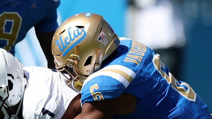 Oct 4, 2025; Pasadena, California, USA;  Penn State Nittany Lions wide receiver Kyron Hudson (1) is tackled by UCLA Bruins linebacker Jonjon Vaughns (6) during the first half at Rose Bowl. Mandatory Credit: Kiyoshi Mio-Imagn Images