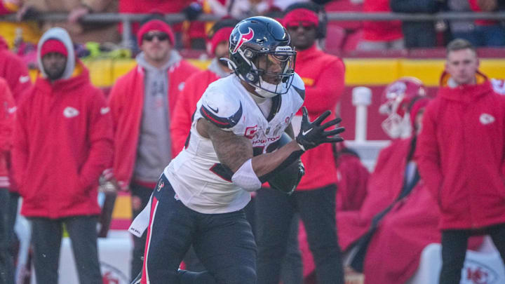 Dec 21, 2024; Kansas City, Missouri, USA; Houston Texans running back Joe Mixon (28) returns a kick against the Kansas City Chiefs during the first half at GEHA Field at Arrowhead Stadium. Mandatory Credit: Denny Medley-Imagn Images
