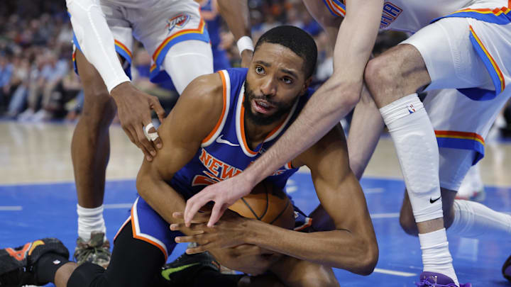 New York Knicks guard Mikal Bridges (25) and Oklahoma City Thunder center Chet Holmgren (7) fight for a loose ball during the first half at Paycom Center. New York Knicks guard Mikal Bridges (25) and Oklahoma City Thunder center Chet Holmgren (7) fight for a loose ball during the first half at Paycom Center.