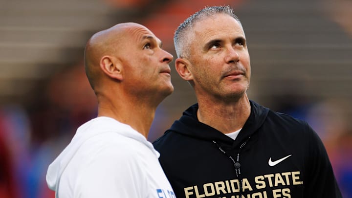 Nov 29, 2025; Gainesville, Florida, USA; Florida Gators interim head coach Billy Gonzales and Florida State Seminoles head coach Mike Norvell talk before the game at Ben Hill Griffin Stadium. Mandatory Credit: Matt Pendleton-Imagn Images Nov 29, 2025; Gainesville, Florida, USA; Florida Gators interim head coach Billy Gonzales and Florida State Seminoles head coach Mike Norvell talk before the game at Ben Hill Griffin Stadium. Mandatory Credit: Matt Pendleton-Imagn Images