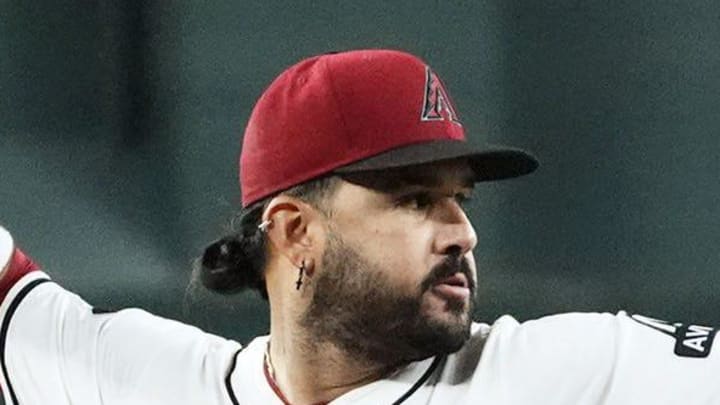 Arizona Diamondbacks third baseman Eugenio Suarez fields the ball and throws out Houston Astros' Yainer Diaz in the first inning at Chase Field in Phoenix on July 23, 2025.