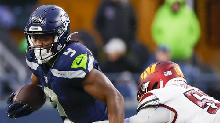 Seattle Seahawks running back Kenneth Walker III rushes against Washington Commanders linebacker Jamin Davis. Seattle Seahawks running back Kenneth Walker III rushes against Washington Commanders linebacker Jamin Davis.