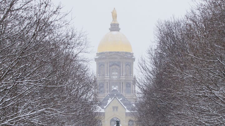 Feb. 26, 2020; South Bend, IN, USA; People make their way along a path near the administration building, known as \"The Golden Dome\" Wednesday, Feb. 26, 2020 on the campus of Notre Dame in South Bend, Indiana. 