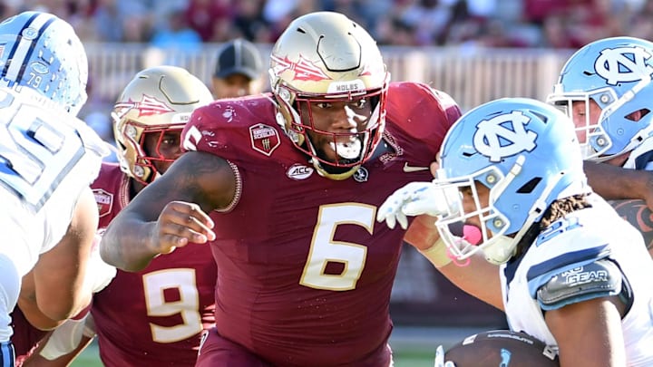 Nov 2, 2024; Tallahassee, Florida, USA;  Florida State Seminoles defensive tackle Darrell Jackson Jr (6) pursues North Carolina Tarheels running back Davion Gause (21) in the second quarter at Doak S. Campbell Stadium. Mandatory Credit: Robert Myers-Imagn Images