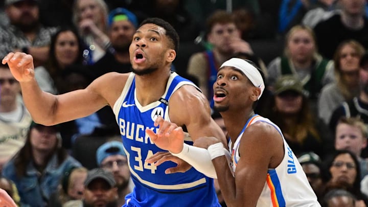 Mar 16, 2025; Milwaukee, Wisconsin, USA;  Milwaukee Bucks forward Giannis Antetokounmpo (34) and Oklahoma City Thunder guard Shai Gilgeous-Alexander (2) jostles for position under the basket in the second quarter at Fiserv Forum. Mandatory Credit: Benny Sieu-Imagn Images